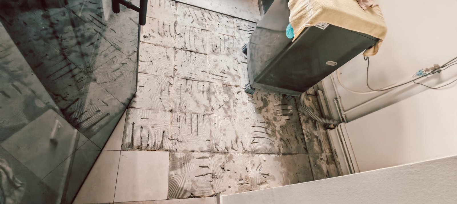 Floor tiles removed for repair and reinstatement