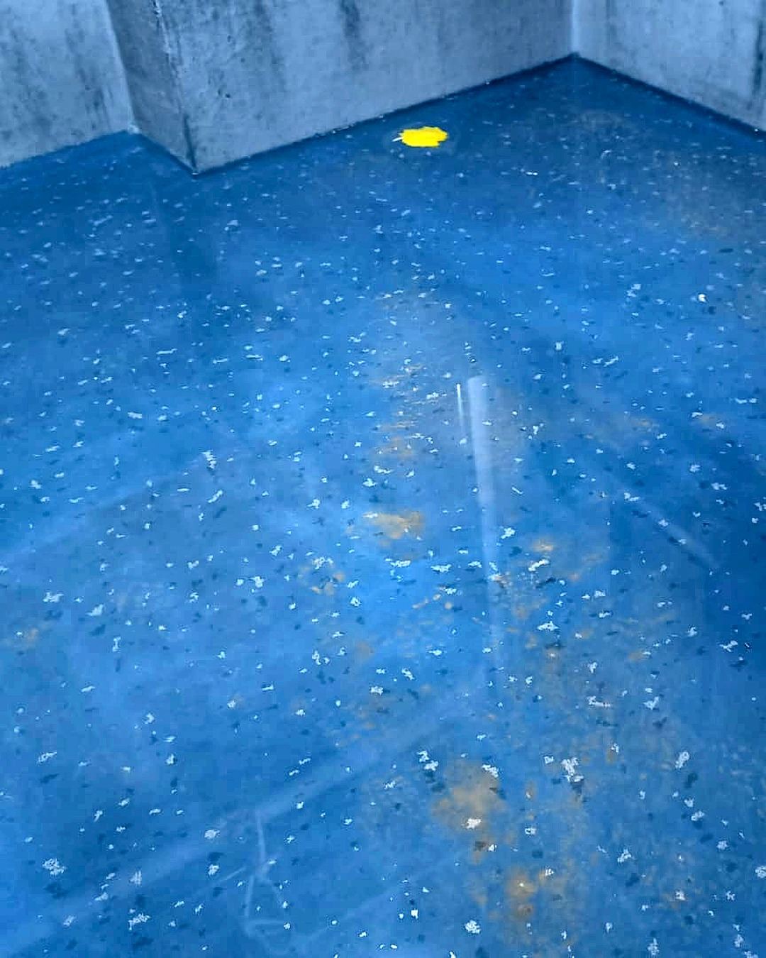 Close-up of blue waterproofing membrane on bathroom floor