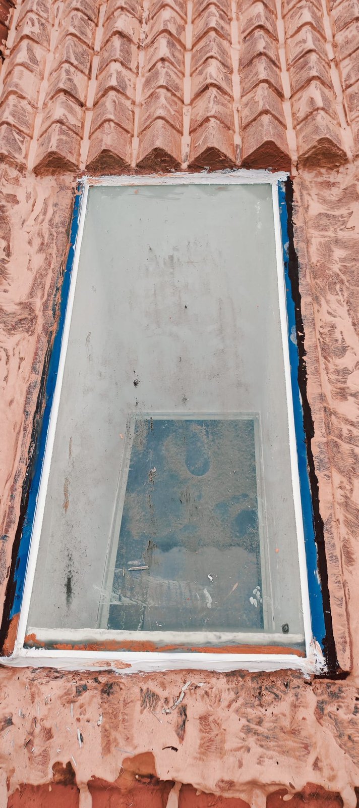 Close-up of sealant and blue detailing around a roof skylight