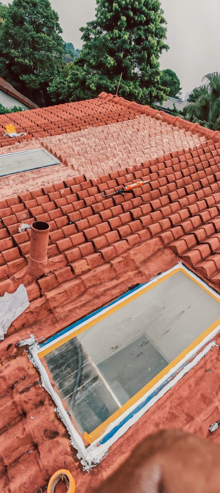 Roof skylight being sealed and coated for waterproofing